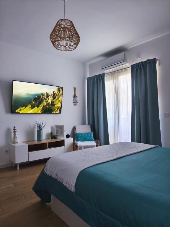 a bedroom with a bed and a chair and a window at Benalbeach Smart Suite in Benalmádena