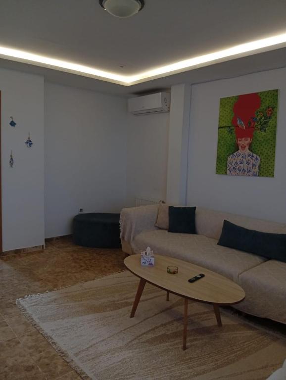 a living room with a couch and a coffee table at Apartment cosy in Sidi Daoud