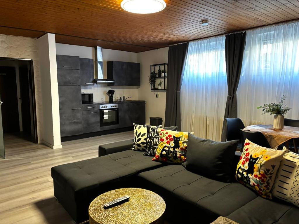 a living room with a couch and a table at Bad Rothenfelde Residence in Bad Rothenfelde