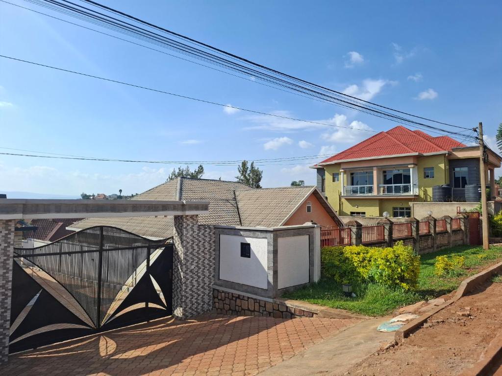 a house with a gate in front of it at Kigali Great Garden in Kigali