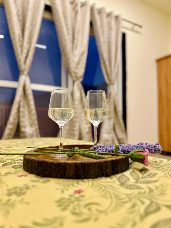 two glasses of white wine sitting on a table at mountain hideaway in Pushkar