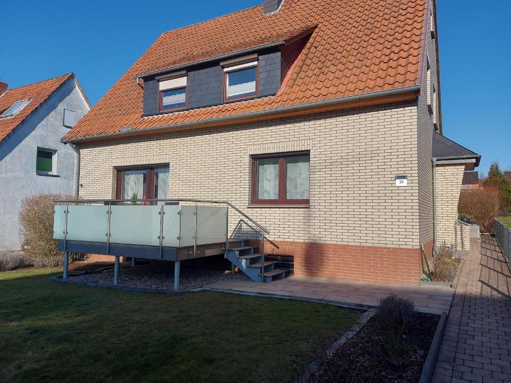 a house with a staircase in front of it at Ferienwohnung Bergstraße in Extertal