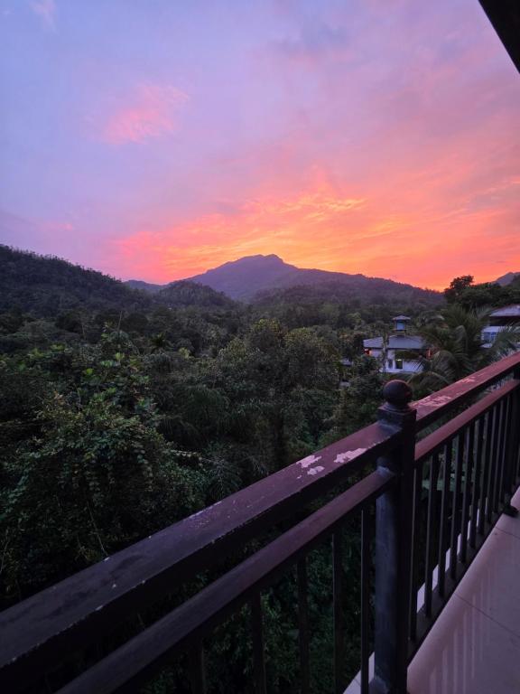 a view of a mountain from a balcony at sunset at X38 Venture in Kitulgala