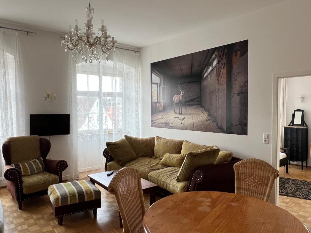 a living room with a couch and a table at FeWo Seliger am Schloßplatz in Meersburg