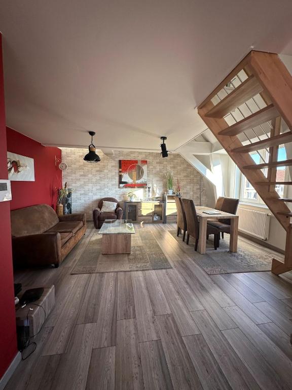 a living room with a couch and a table at The2 Work or holiday apartment in Godshuis