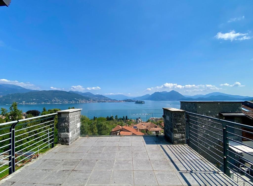 a balcony with a view of a lake and mountains at Refugio Azul Baveno, pool and private parking in Baveno