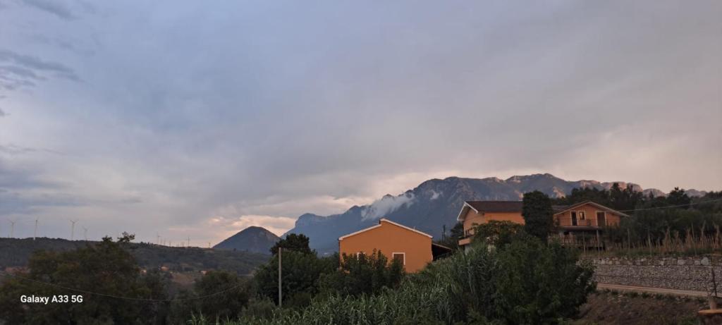 a group of houses and mountains in the distance at Valle degli Alburni in Postiglione