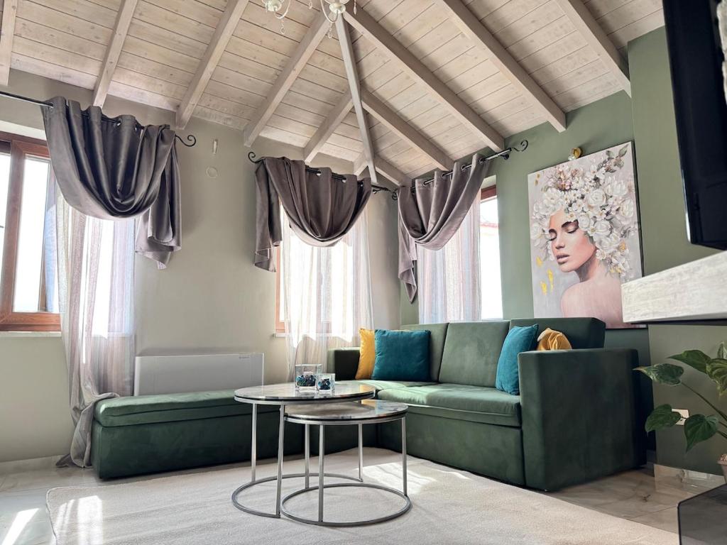 a living room with a green couch and a table at Bloom Garden 3 in Mytilene