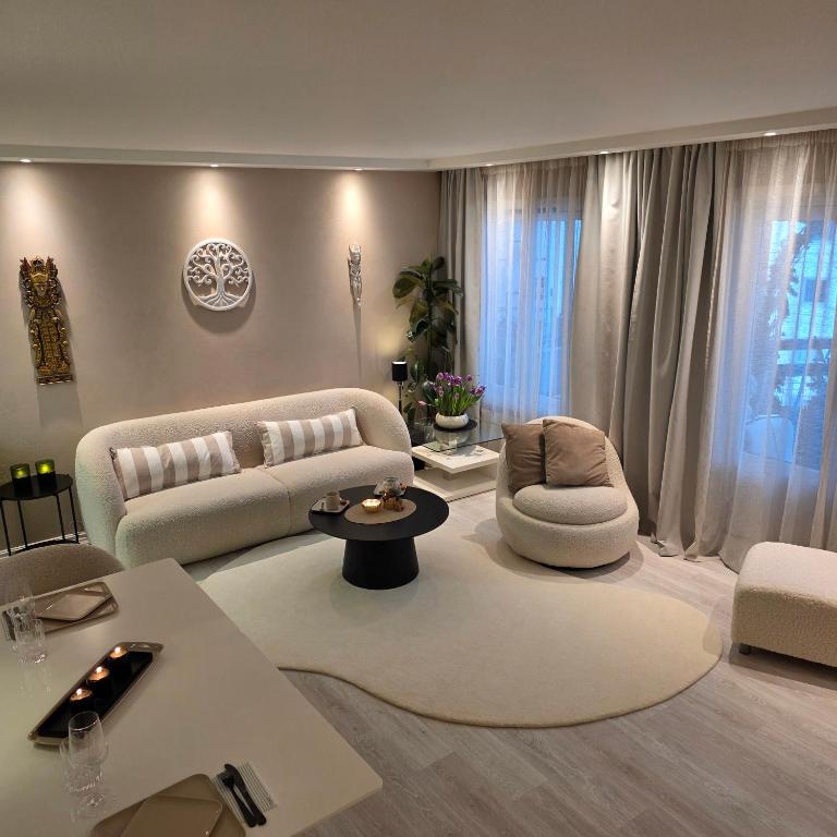 a living room with a couch and chairs and a table at Apartment, everything close in Hamar