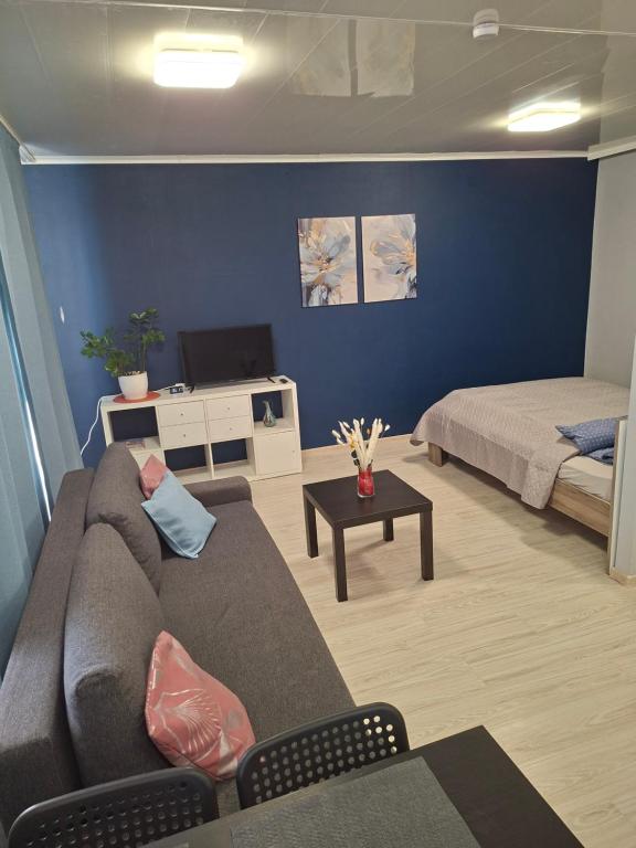 a living room with a couch and a bed at Jelena Apartment 69 in Rēzekne