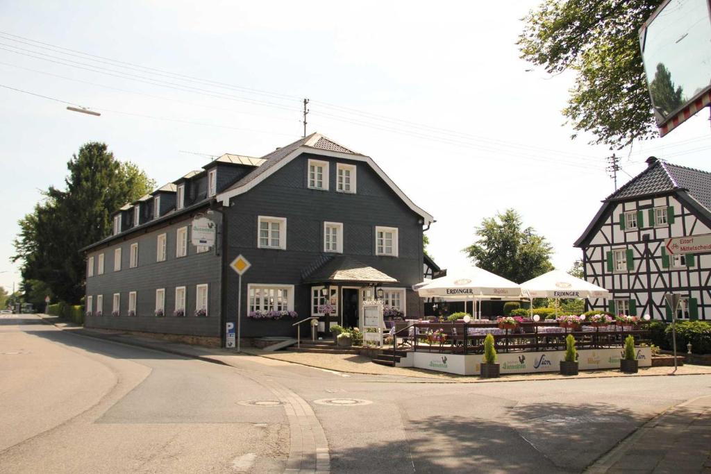 a large black building with a market in front of it at Landhaus Süchterscheid in Süchterscheid