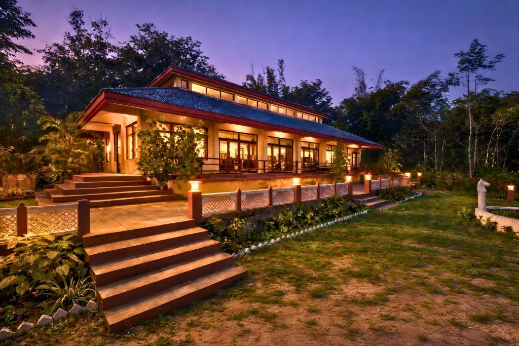 a house with a staircase leading up to it at juSTa The Bagh, Kanha in Bhīmlāt