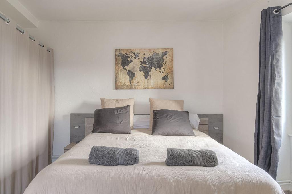 a bedroom with a large bed with two pillows on it at Appart lumineux, WIFI haut débit, proche gare 7 min, Lyon 15 min in Couzon-au-Mont-dʼOr