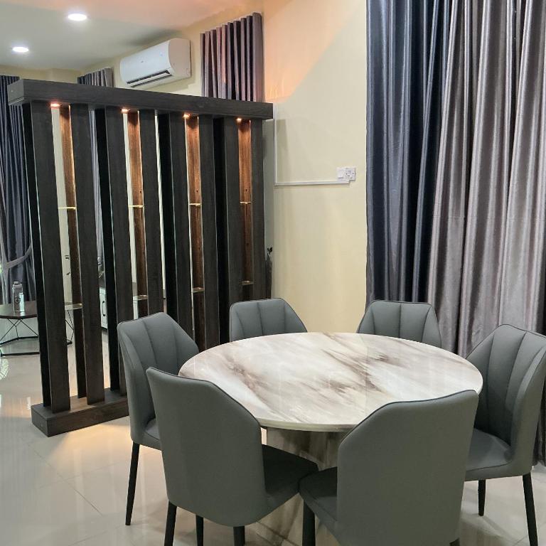 a dining room with a marble table and chairs at HD DOUBLE-STORY House in Banting