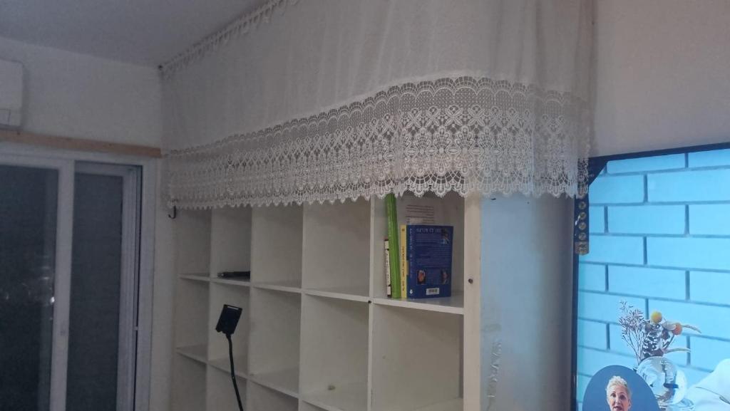 a white curtain on a shelf in a room at Big Room Ashdod in Ashdod