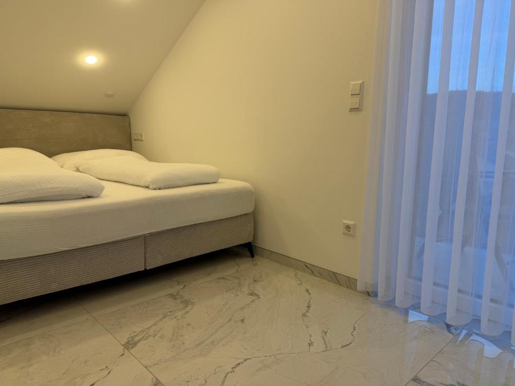 a small bedroom with a bed and a window at Alea in Tuttlingen