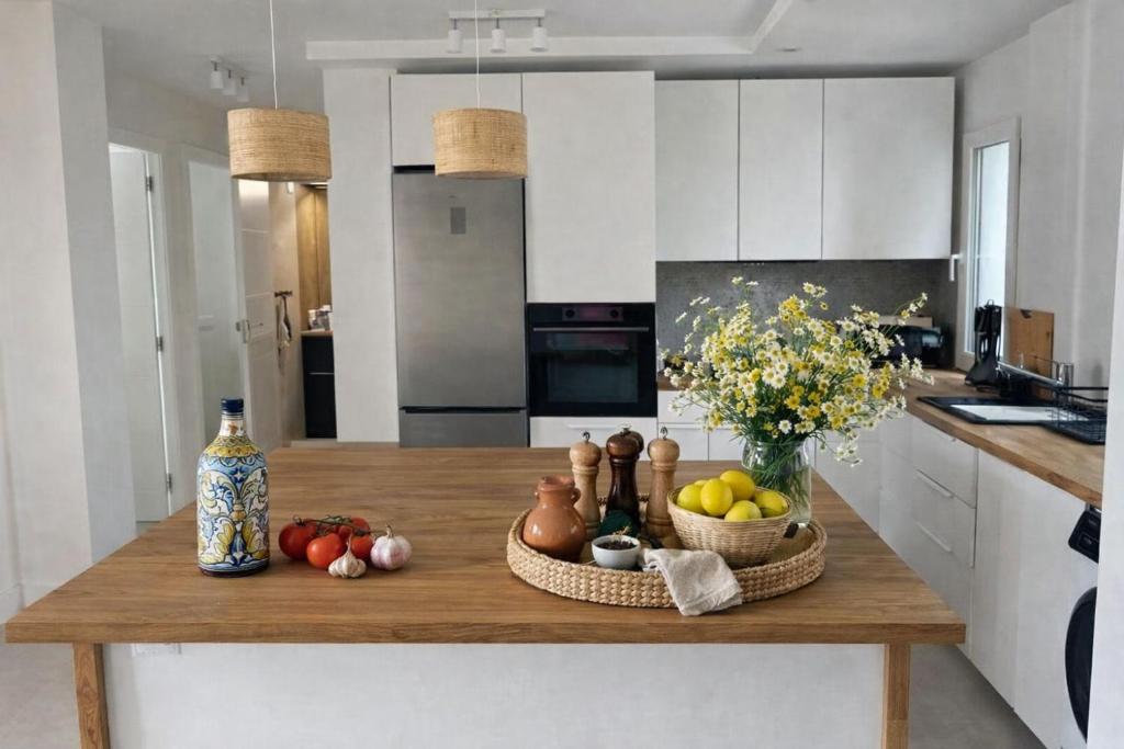 a kitchen with a table with fruits and vegetables on it at AriaSpot Alicante in Gran Alacant