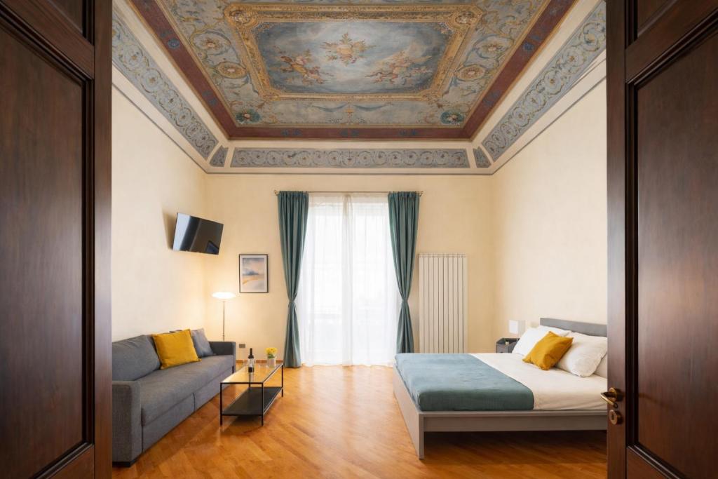 a room with a bed and a couch and a ceiling at Open Sicily Quattro Canti Apartments in Palermo