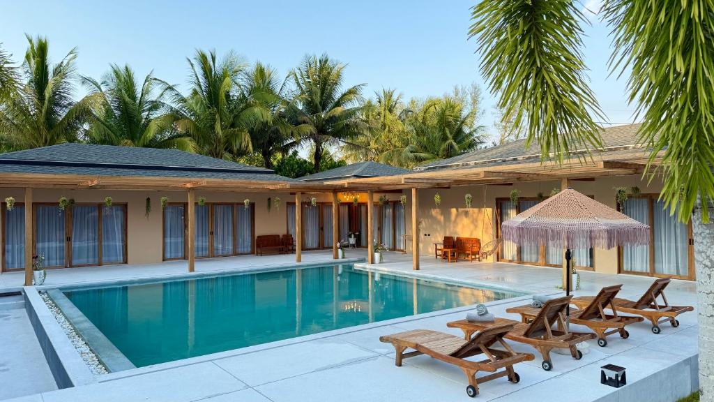 a villa with a swimming pool and a resort at Private Pool Villa in Khao Lak