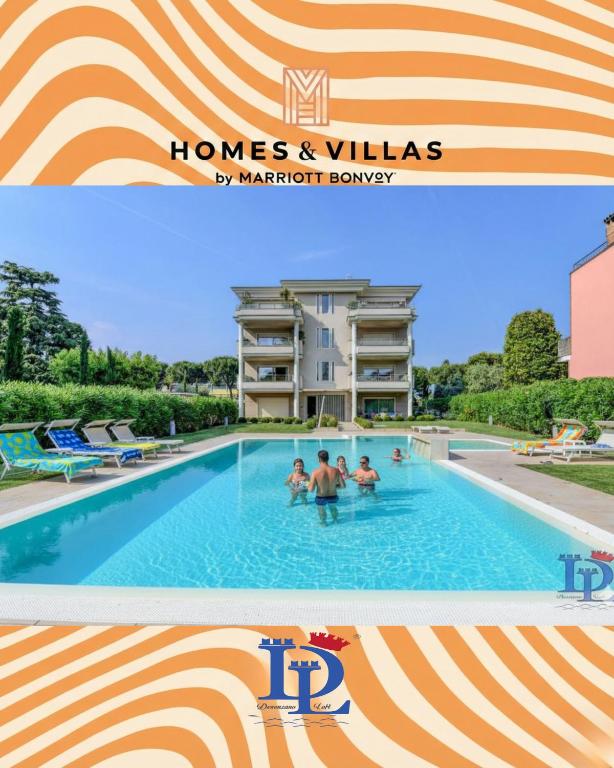 a hotel with a swimming pool in front of a building at Oscar Luxury Suite DesenzanoLoft Official Partner Homes & Villas by Marriott Bonvoy in Desenzano del Garda