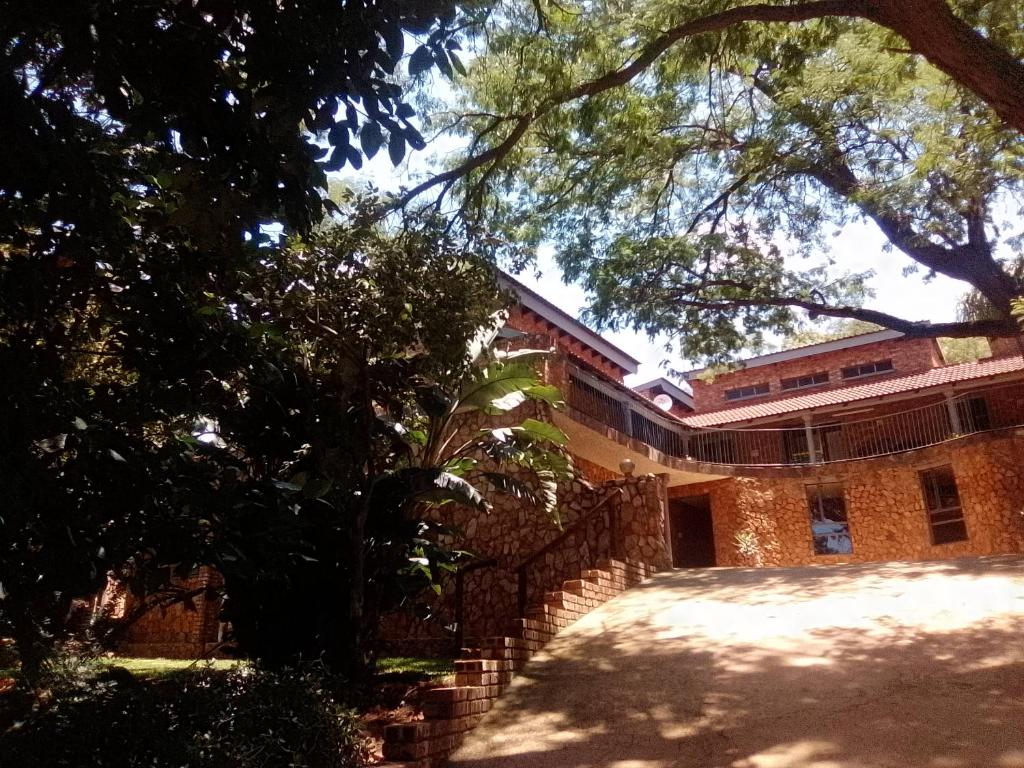 a brick building with a fence in front of it at Mountain Guesthouse in Pretoria