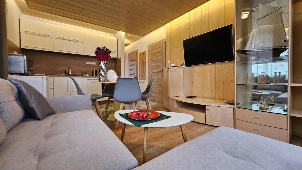 a living room with a couch and a table at Crown Apartment Lesná in Stará Lesná