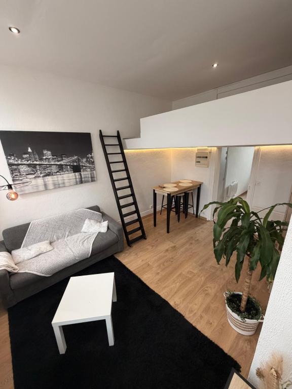 a living room with a couch and a table at LB studio in Dunkerque
