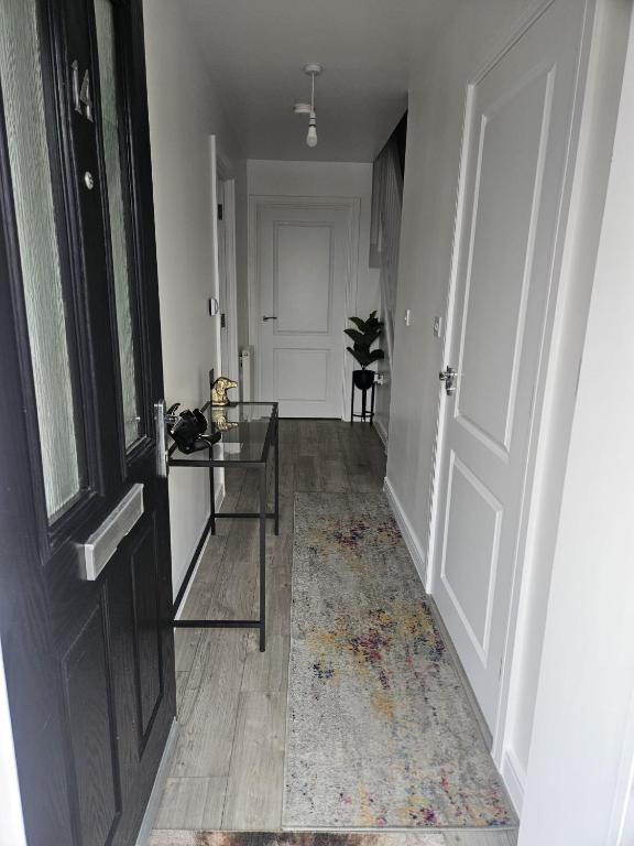 a hallway with a glass table and a door at The Brown Rest House in Gravesend