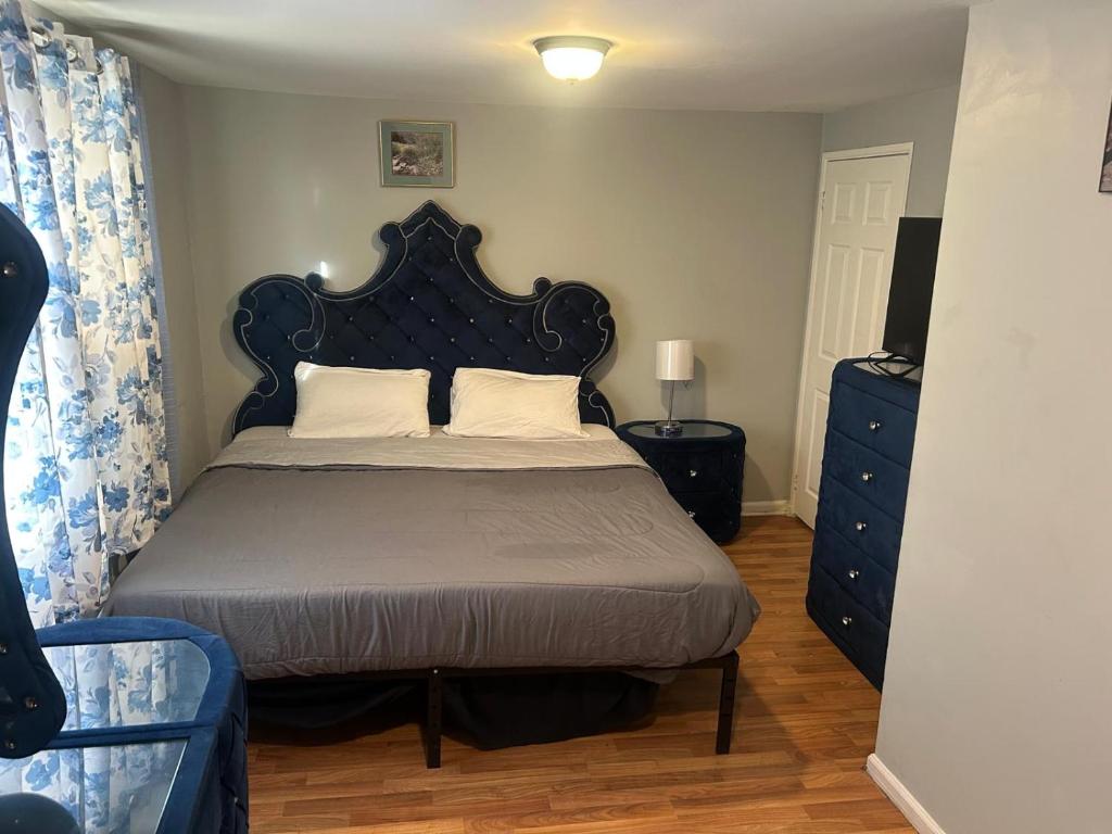 a bedroom with a bed with a black headboard at Grove 3- King Bed with Private Bathroom in Irvington