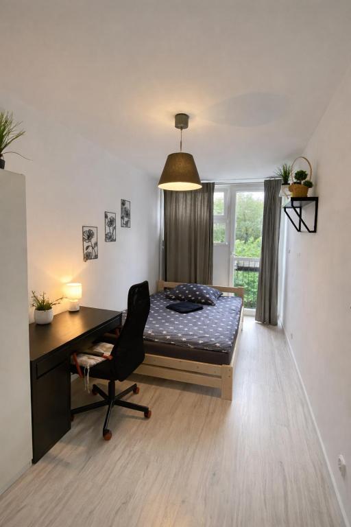a bedroom with a desk and a bed in a room at Rooms in Warsaw - G9 in Warsaw