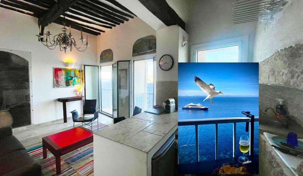 a living room with a bird flying over the ocean at Fleur de Falaise in Bonifacio