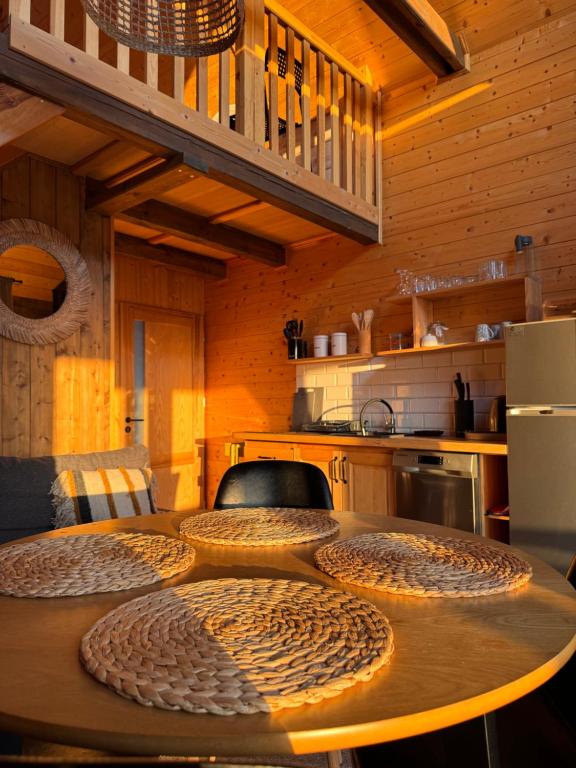 a kitchen with a wooden table with chairs around it at Wypoczynek pod Lipami in Ruciane-Nida