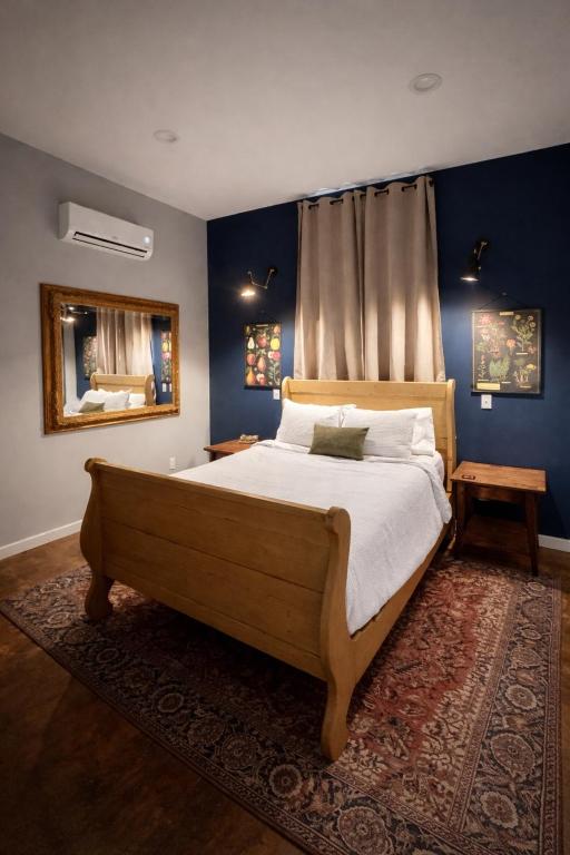 a bedroom with a large bed with blue walls at Yellowstone Hideaway in Livingston
