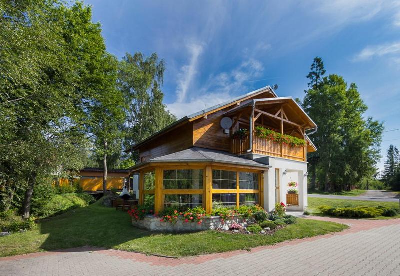 a house with a balcony on top of it at Vila Kantor in Vyšné Hágy
