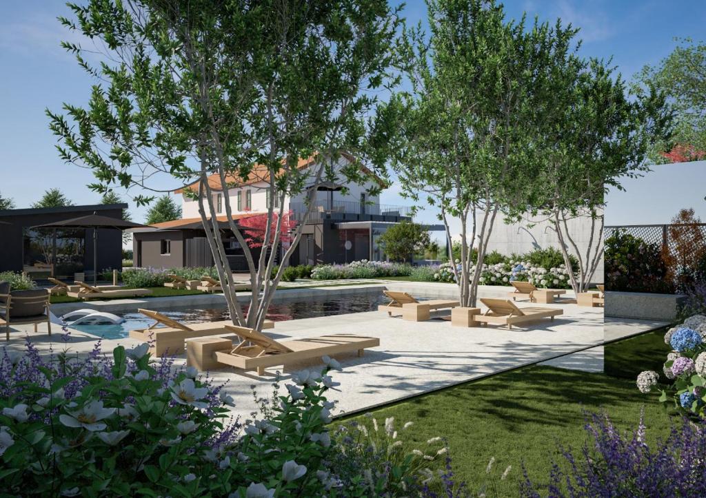a garden with lounge chairs and trees at Memento Agriturismo in Cervia