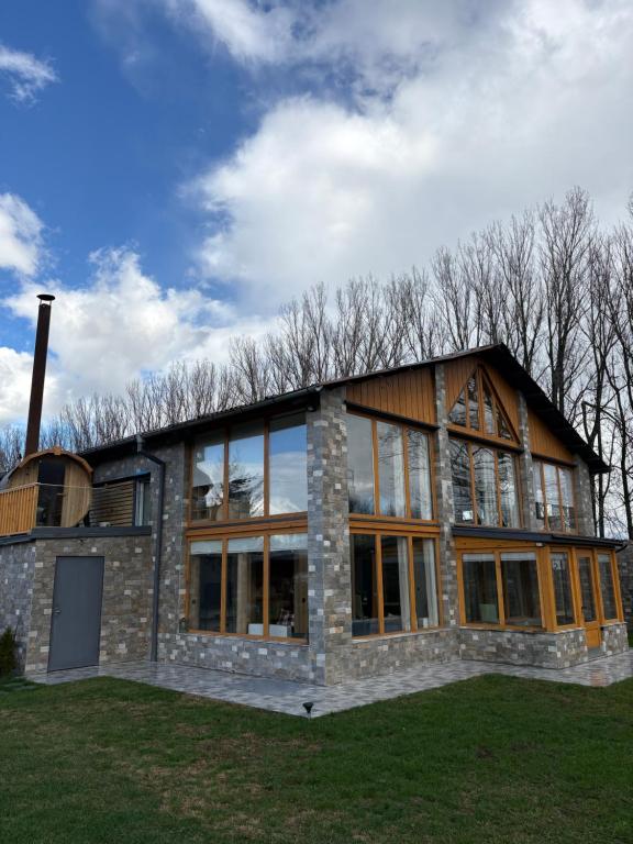 a large brick building with windows on a field at Loft Chalet Bansko in Bansko