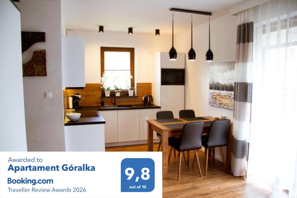 a kitchen and dining room with a table and chairs at Apartament Góralka in Jaworki