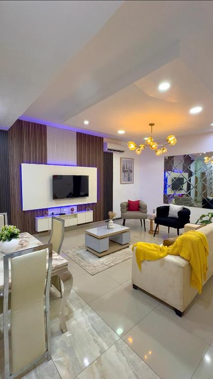 a living room with a couch and a tv at Modern 2BR in Lekki Phase 1 in Lekki