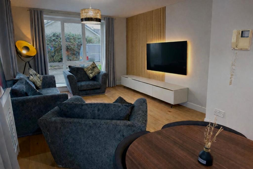 a living room with two couches and a tv at Ebrington apartment central in Clooney Park