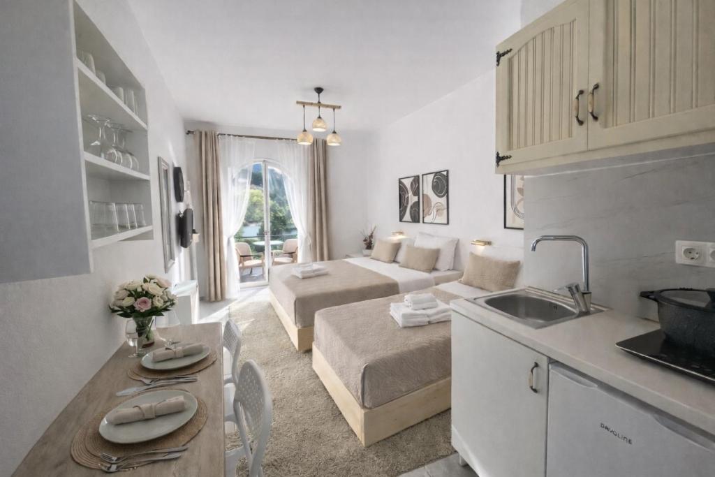 a kitchen and a living room with a bed and a sink at Ameli Studio ,Balcony with Mountain View, Kitchenette, 1km to Beach by likeyourhome in Corfu