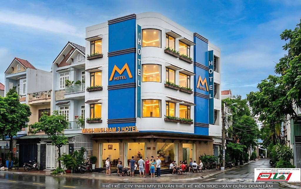 a large building with people standing outside of it at Minh Minh Nam 3 Hotel in Can Tho