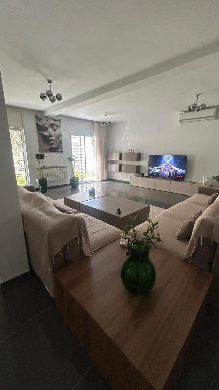 a living room with a couch and a table at Da Dora in Dar el Haj Ahmed Souid