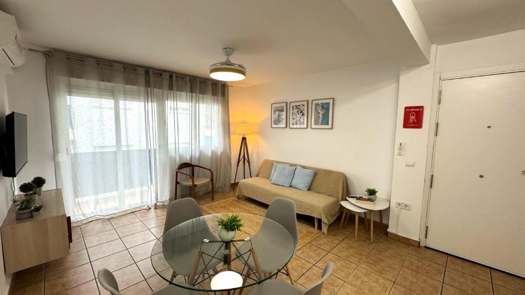 a living room with a couch and a table at Rhys Houses in Altea