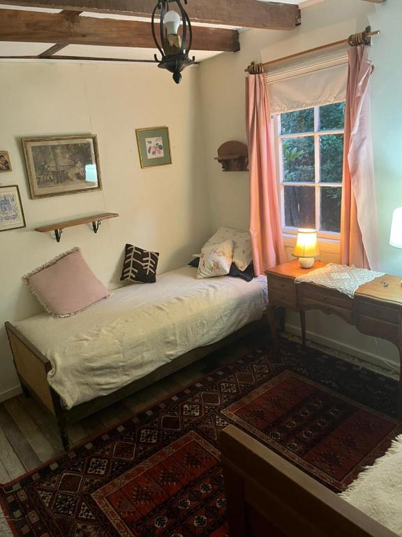a bedroom with two beds and a window at Casa Krampus Hospedaje y Cervecería in Valdivia