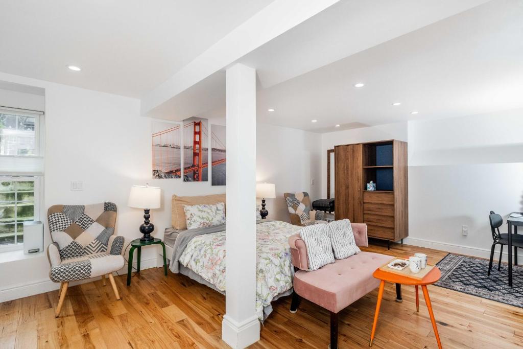 a bedroom with a bed and a chair and a table at Huh's Lodge in San Francisco