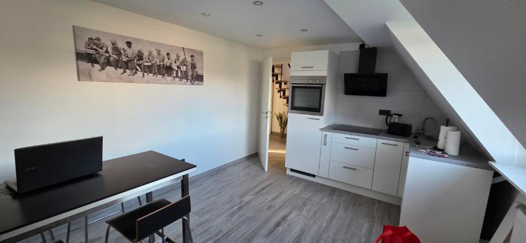a living room with a kitchen and a staircase at casa stadio2 in Leverkusen