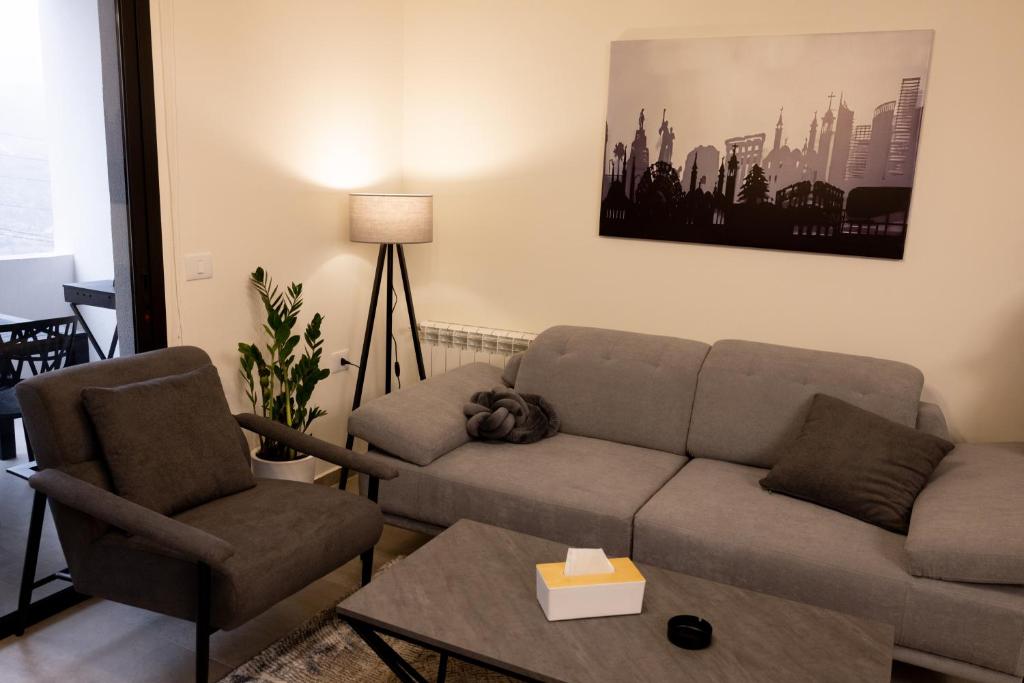a living room with a couch and two chairs at Domaine De Faraya F2 in Nab‘ al Maghārah