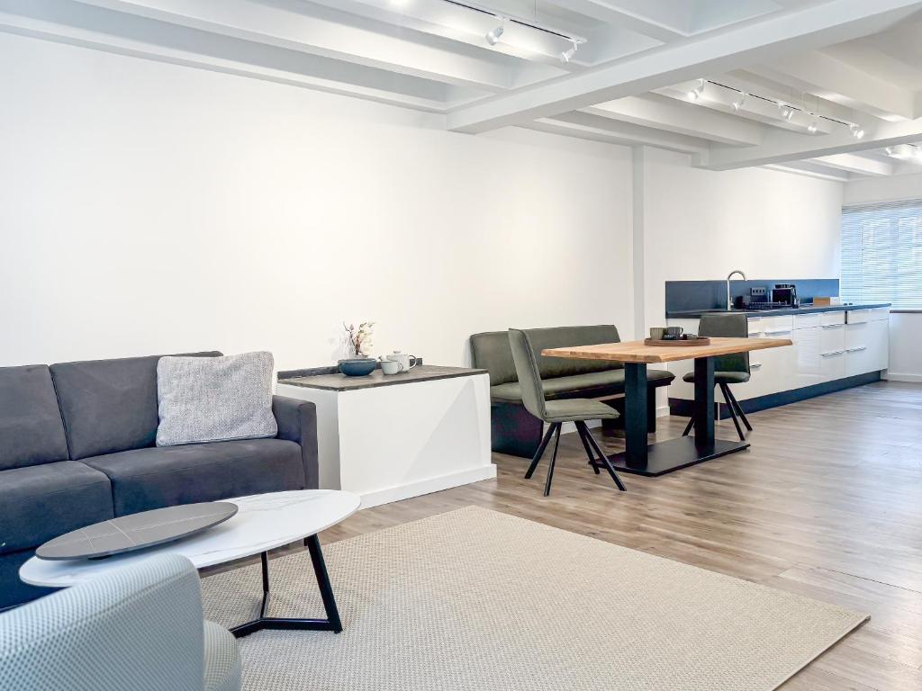 a living room with a couch and a table at Gutshaus am Rhein in Düsseldorf