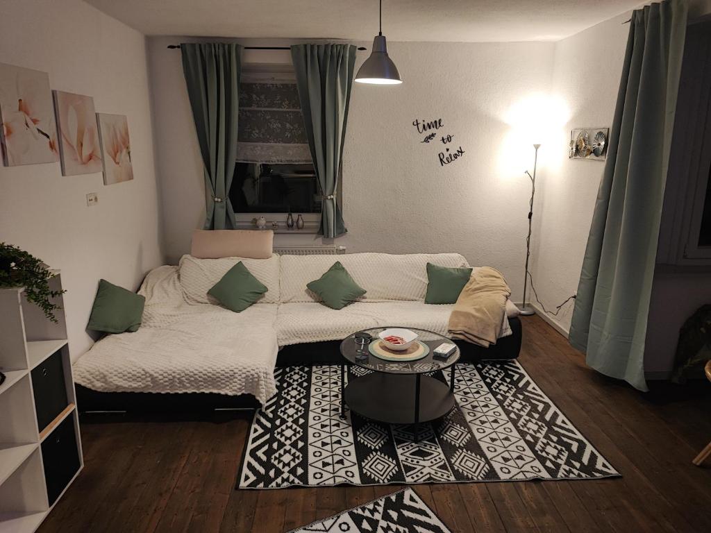 a living room with a couch and a table at Apartment For You in Hameln