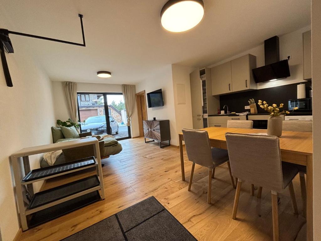 a kitchen and living room with a table and chairs at Apartment Leitner in Haiming